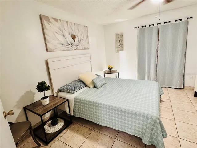 a bedroom with a bed and a painting on the wall