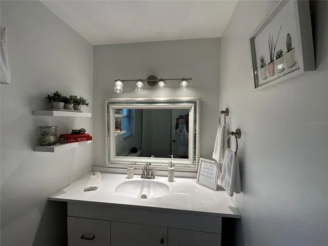 a bathroom with a sink and a mirror