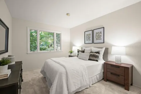 a bedroom with bed and a window