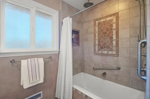 a bathroom with a bathtub and shower