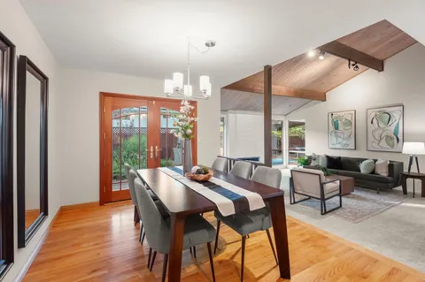 a view of a dining room with furniture window and wooden floor