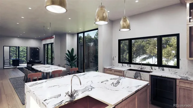 a view of a dining room with furniture large windows and kitchen view