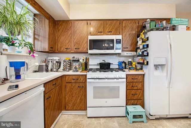 a kitchen with stainless steel appliances granite countertop a refrigerator sink and cabinets