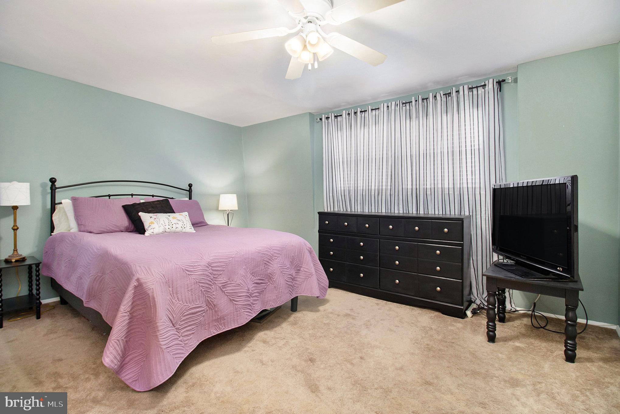 816 Lawler Street Philadelphia, PA 19116 - Photo 14 of 47 a bedroom with a bed and a flat screen tv