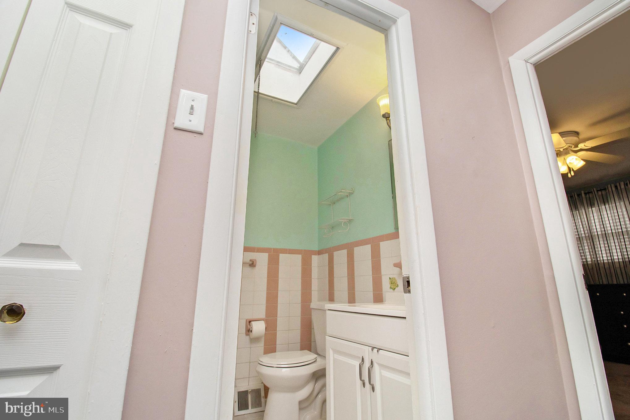 816 Lawler Street Philadelphia, PA 19116 - Photo 20 of 47 a bathroom with a toilet a sink and a mirror
