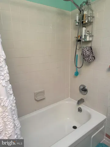 a bathroom with a tub and sink