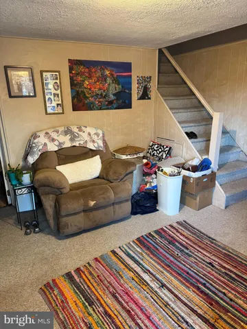 a living room with furniture and flowers