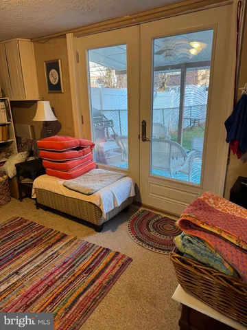 a bedroom with two beds and wooden floor