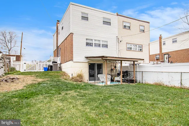 a view of a house with a yard and sitting area