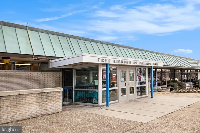 a view of a patio with table and chairs