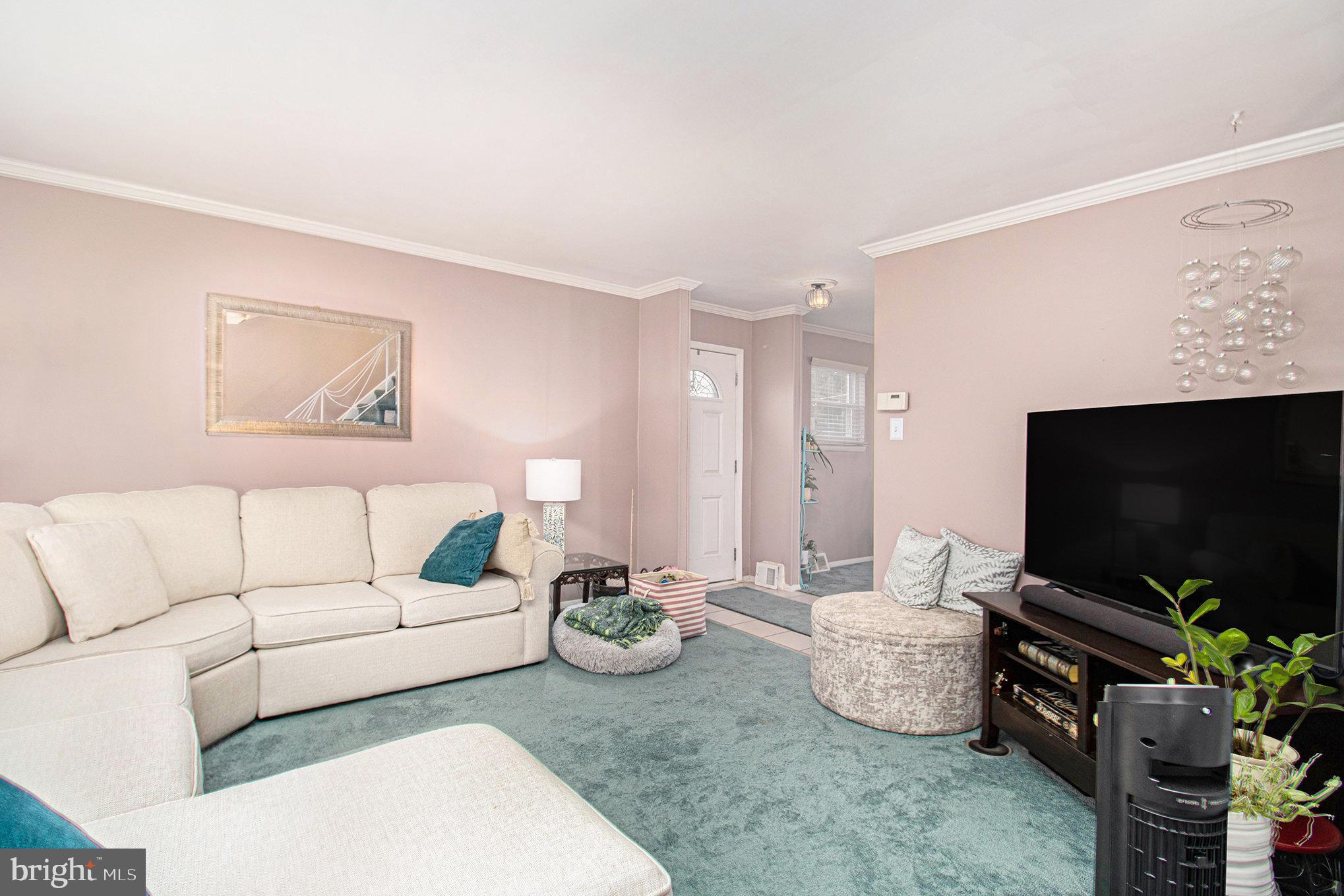 816 Lawler Street Philadelphia, PA 19116 - Photo 7 of 47 a living room with furniture and a flat screen tv