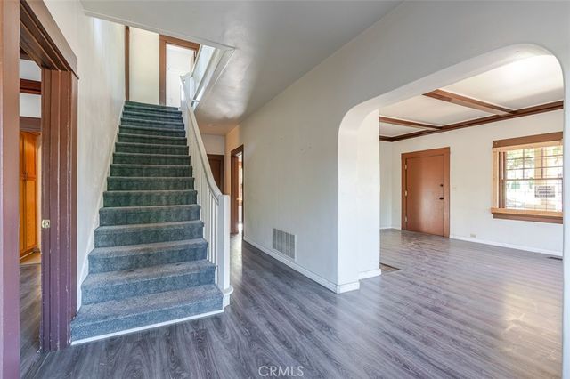 a view of an entryway with wooden floor and door