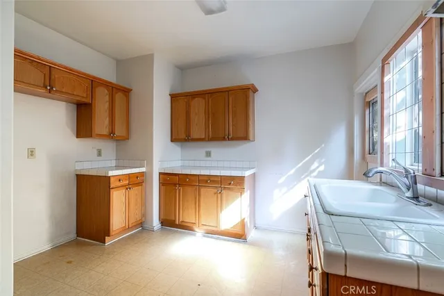 a living room with stainless steel appliances granite countertop furniture a fireplace and a window