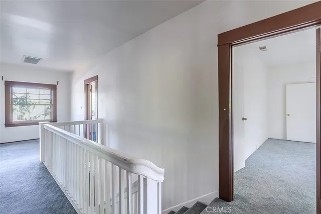 a view of a hallway with windows