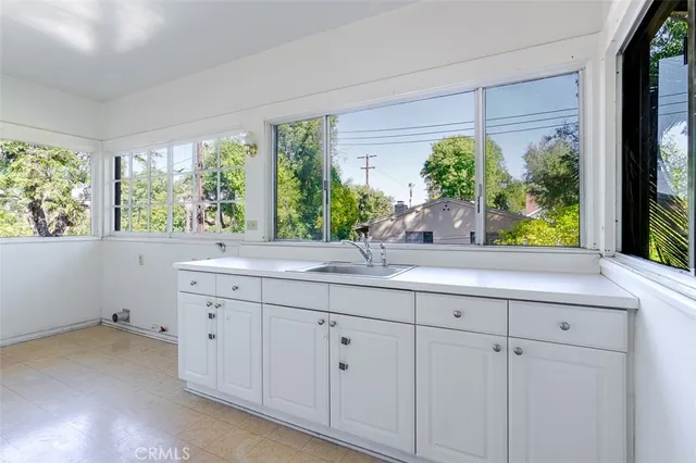 a bathroom with a sink and large window
