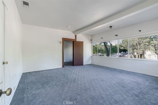 an empty room with large windows