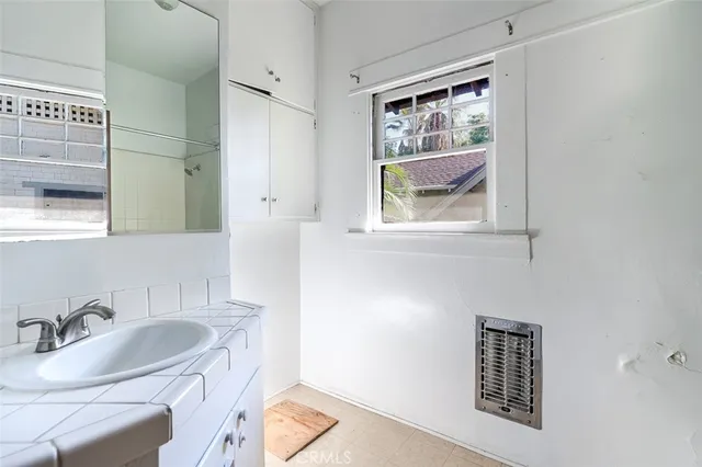 a bathroom with a sink and a window