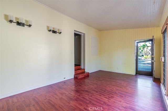 an empty room with closet and wooden floor
