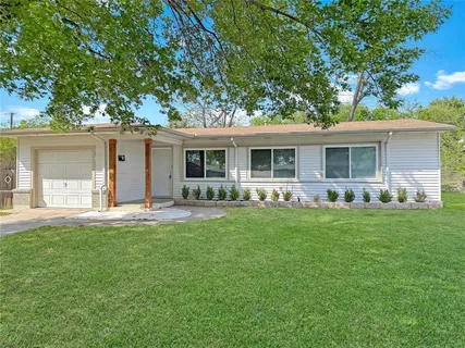 a front view of house with yard and green space