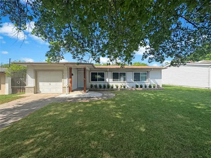 front view of a house with a garden