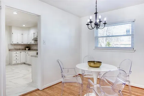 a view of dining room and kitchen with wooden floor