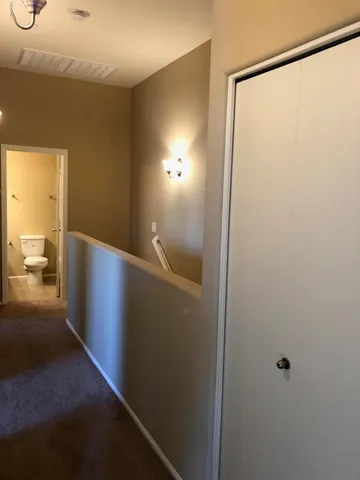 a view of hallway with bathroom