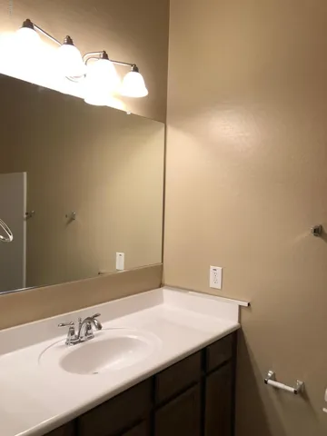 a bathroom with a sink vanity and a mirror