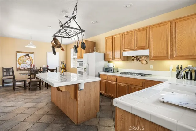 a kitchen with a sink a stove a table and chairs