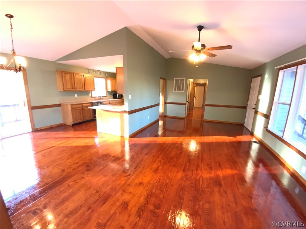 2030 Shallow Well Road Manakin-Sabot, VA 23129 - Photo 3 of 25 a view of a kitchen with kitchen island a sink wooden floor and a counter top space