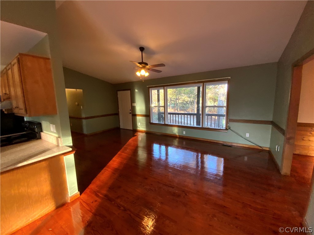2030 Shallow Well Road Manakin-Sabot, VA 23129 - Photo 6 of 25 a view of a living room a dining room with furniture a chandelier and wooden floor