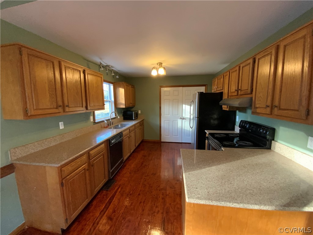 2030 Shallow Well Road Manakin-Sabot, VA 23129 - Photo 8 of 25 a kitchen with stainless steel appliances wooden cabinets a stove top oven a sink and dishwasher