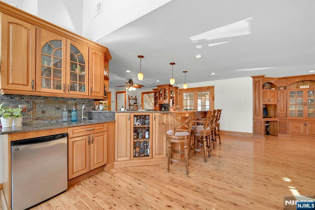 285 Chestnut Ridge Road Woodcliff Lake, NJ 07677 - Photo 27 of 46 a open kitchen with stainless steel appliances granite countertop a stove top oven a sink a dining table and chairs with wooden floor