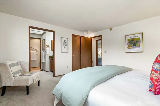 a spacious bedroom with a bed and a couch