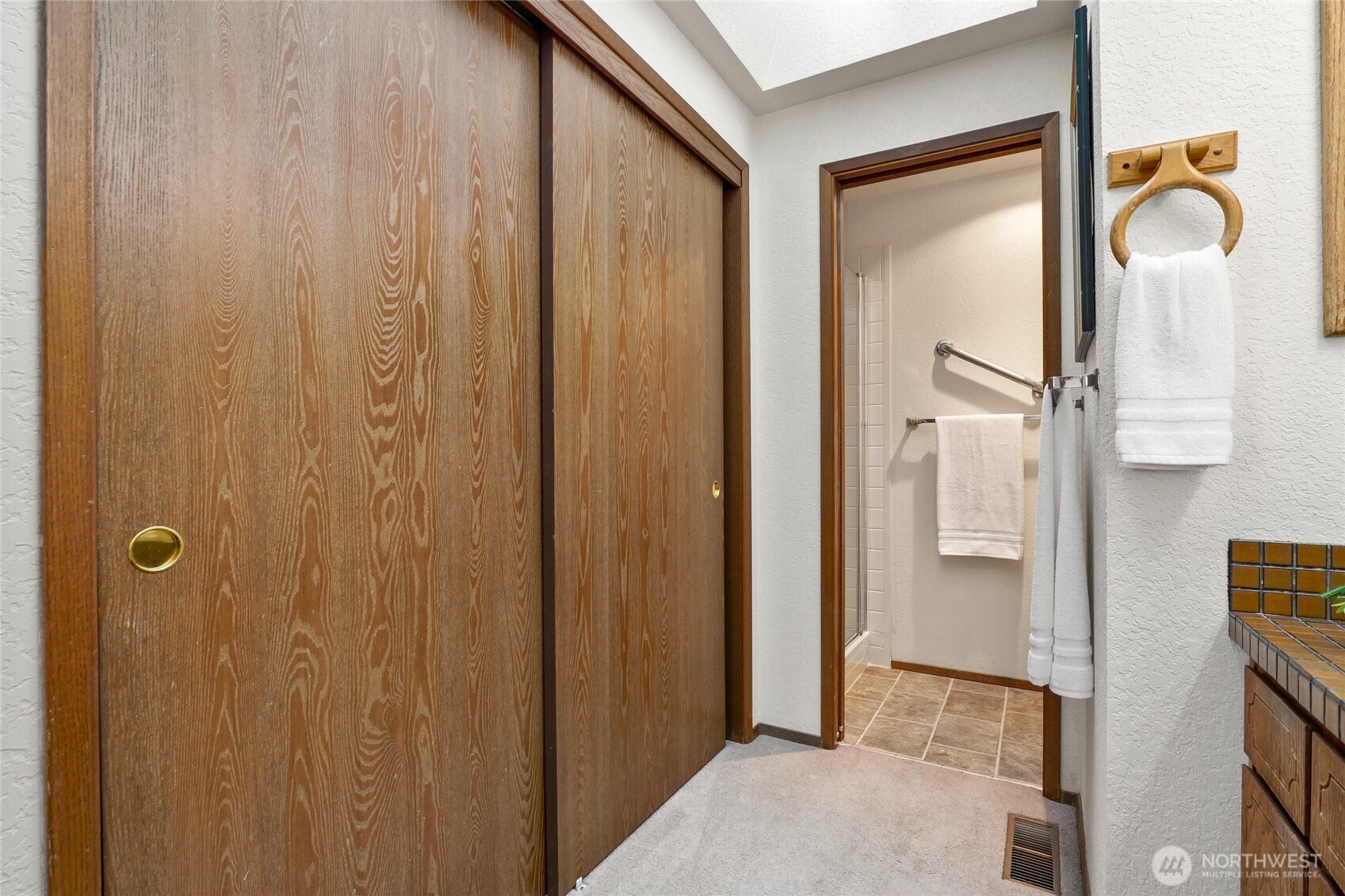 401 169th Street Southeast Bothell, WA 98012 - Photo 17 of 27 a bathroom with a glass shower door and a mirror