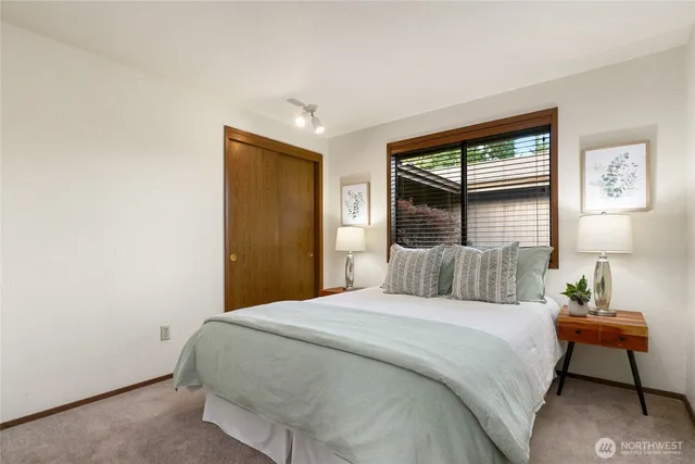 a bedroom with a bed and a night stand