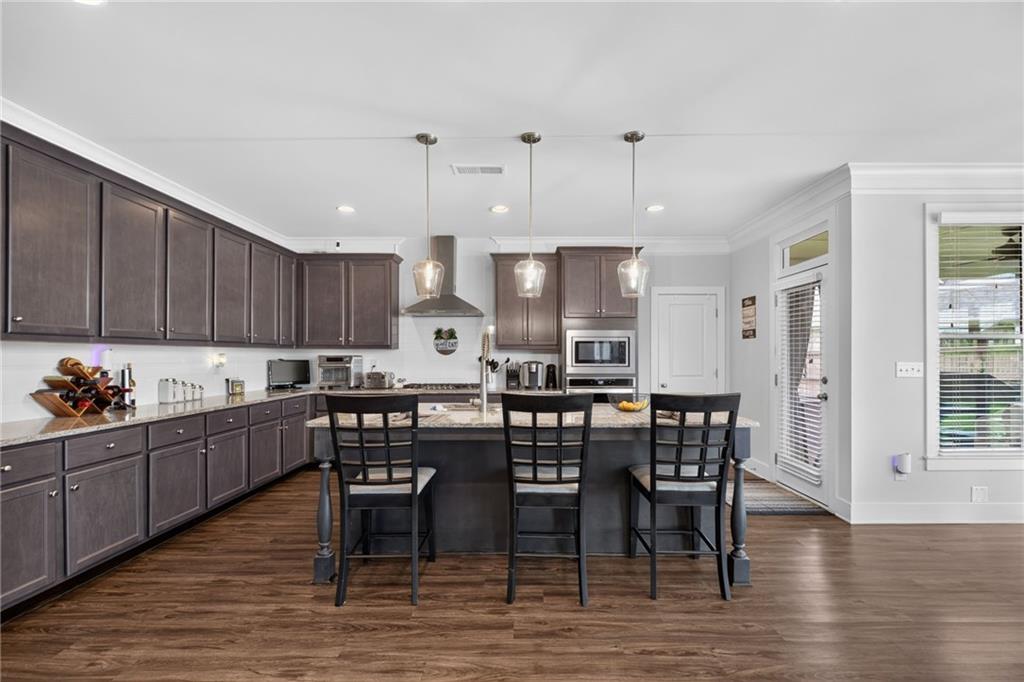 139 Manchester Lane Villa Rica, GA 30180 - Photo 15 of 60 a kitchen with stainless steel appliances kitchen island granite countertop a table chairs sink and cabinets