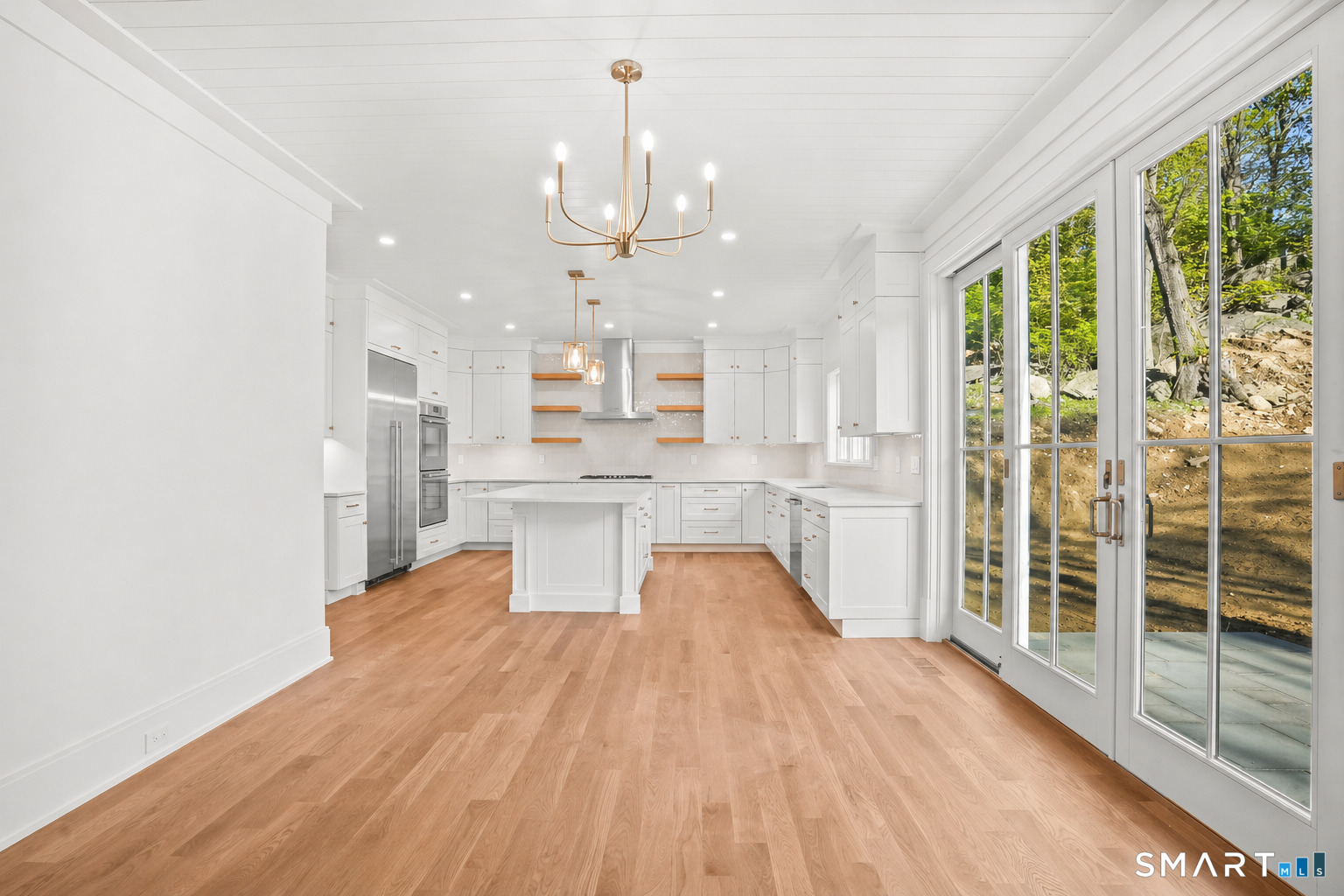 20 Locust Hill Road Darien, CT 06820 - Photo 6 of 30 Island kitchen with casual eating area and sliders leading out to patio
