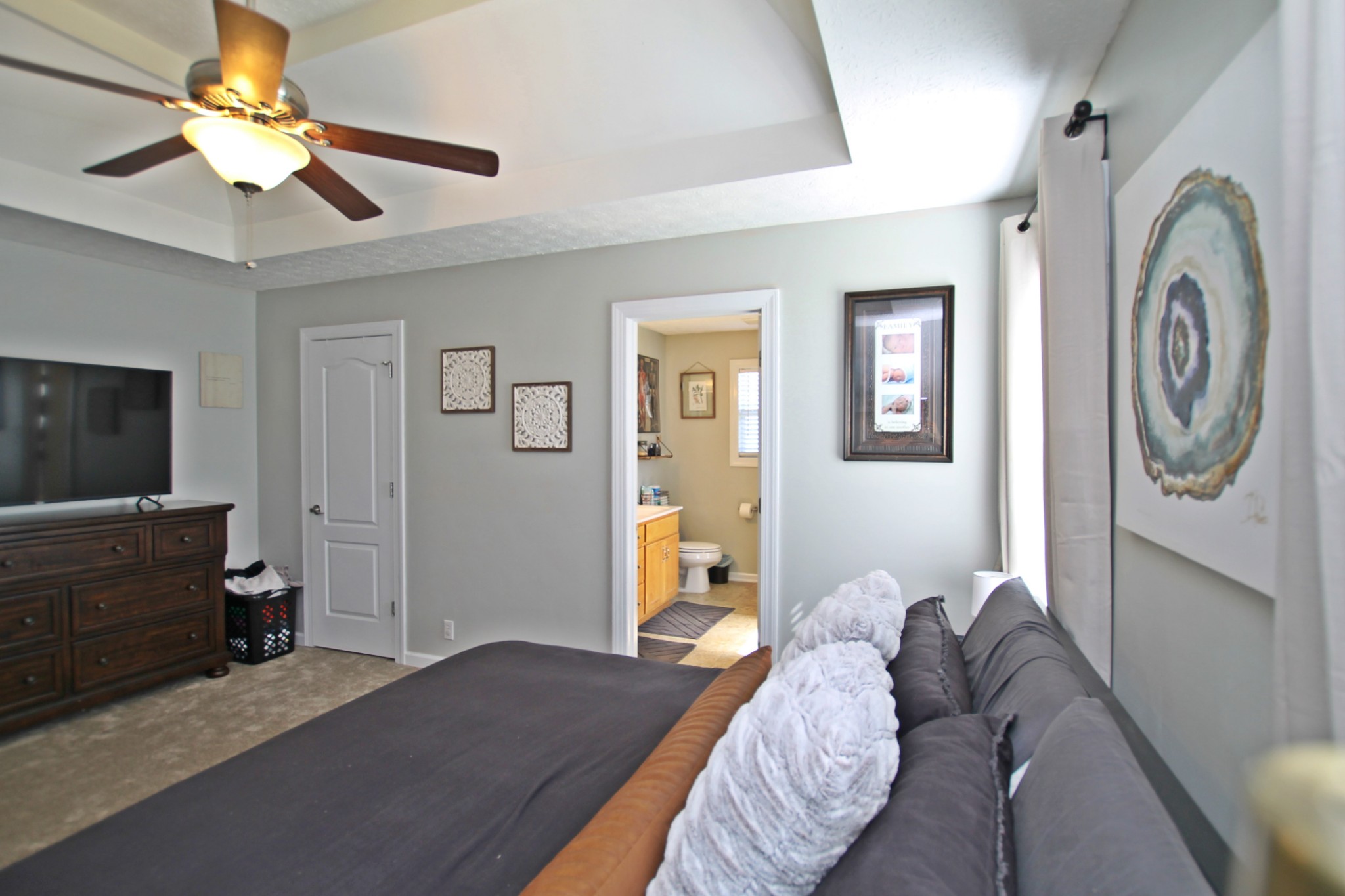 140 Fieldstone Lane Springfield, TN 37172 - Photo 17 of 41 a bedroom with a bed and a chandelier