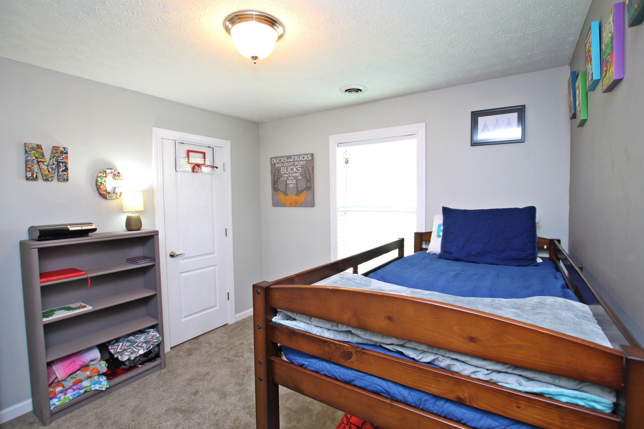 140 Fieldstone Lane Springfield, TN 37172 - Photo 26 of 41 a bedroom with a bed and a chandelier