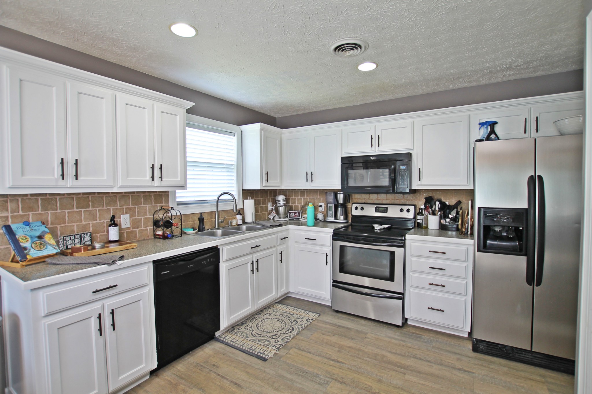 140 Fieldstone Lane Springfield, TN 37172 - Photo 8 of 41 a kitchen with white cabinets and stainless steel appliances