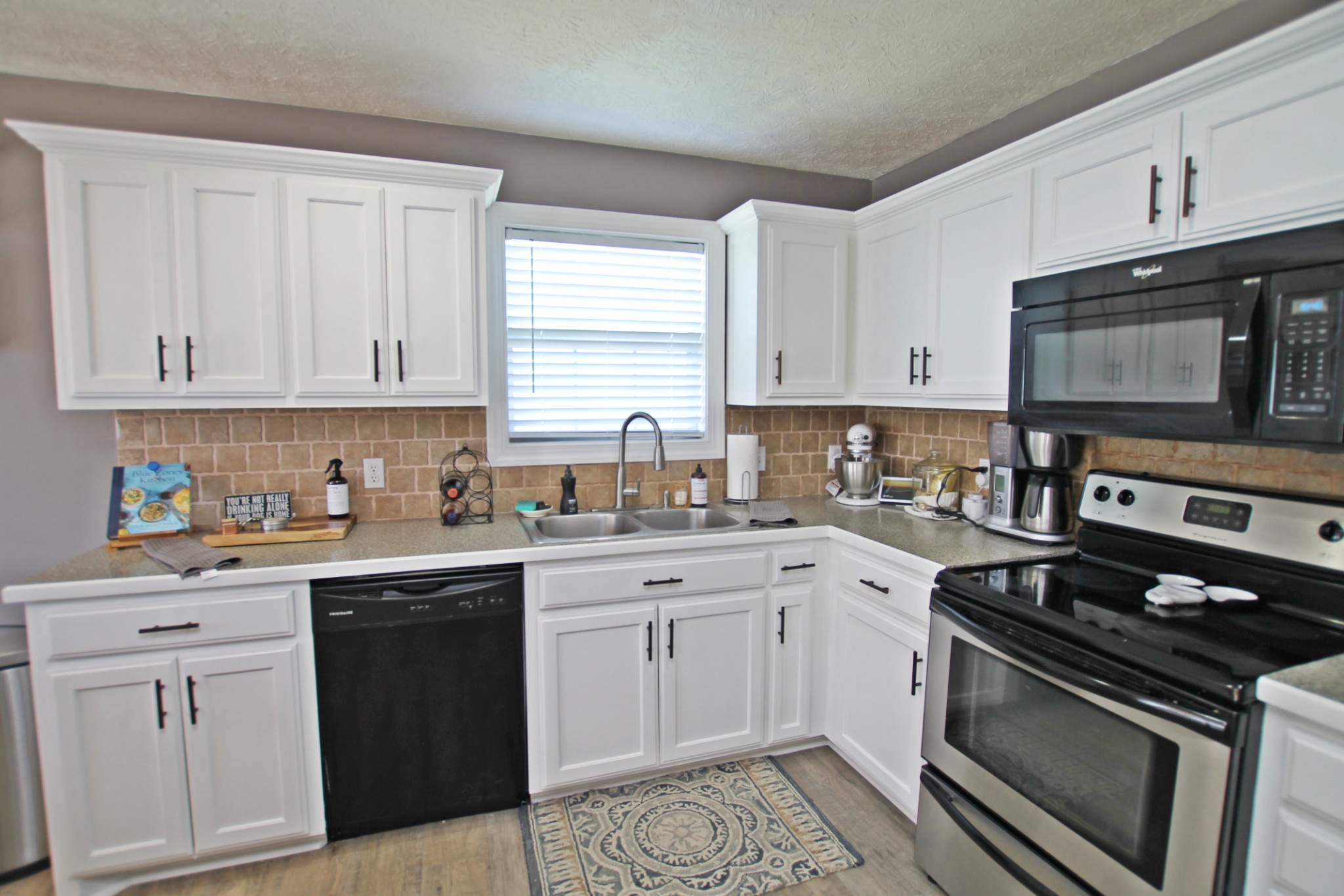140 Fieldstone Lane Springfield, TN 37172 - Photo 9 of 41 a kitchen with granite countertop white cabinets and stainless steel appliances