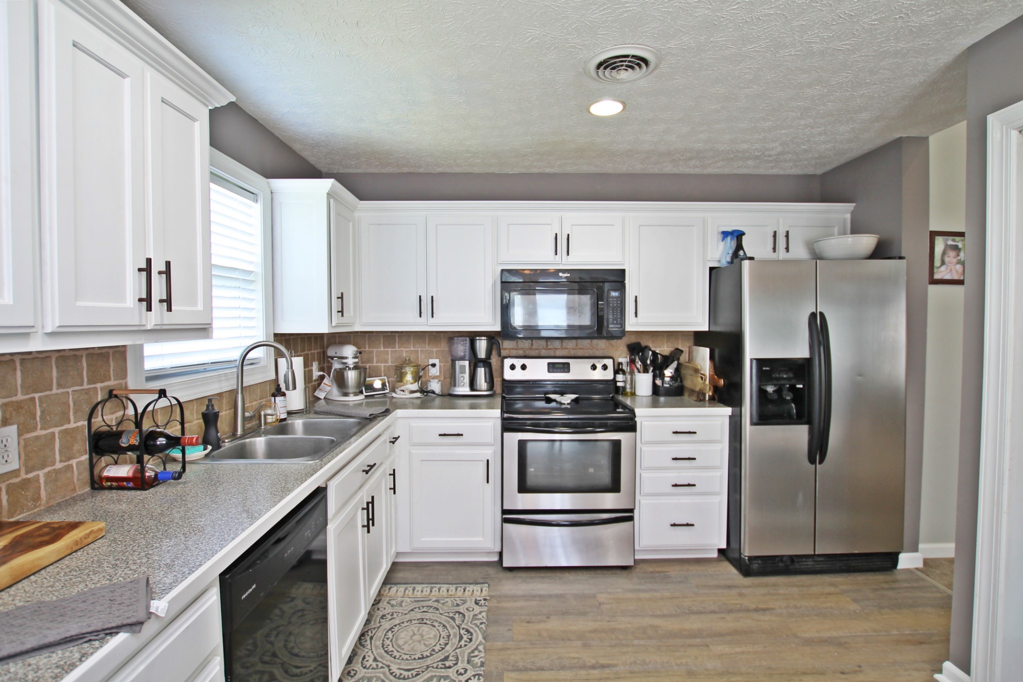 140 Fieldstone Lane Springfield, TN 37172 - Photo 10 of 41 a kitchen with stainless steel appliances a stove refrigerator sink and cabinets