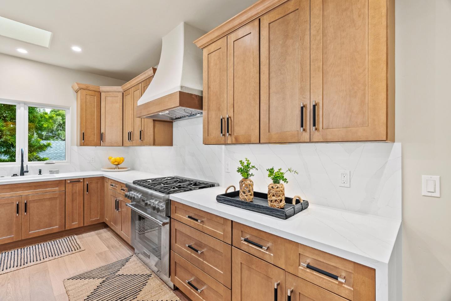 2869 Forest Lodge Road Pebble Beach, CA 93953 - Photo 11 of 34 a kitchen with stainless steel appliances granite countertop a sink a stove and cabinets