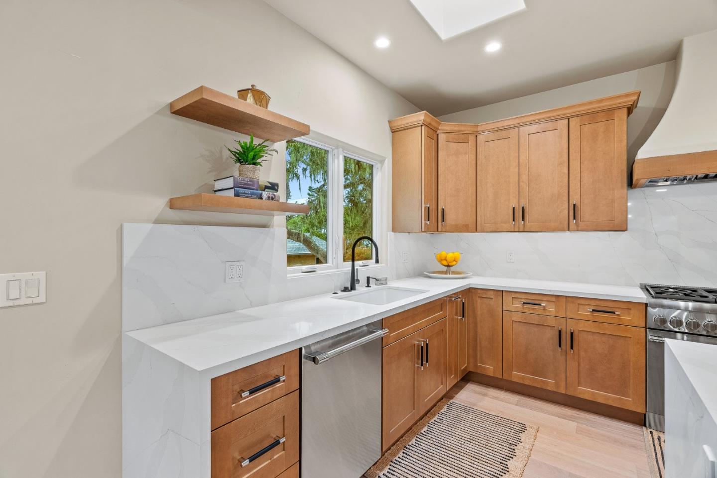 2869 Forest Lodge Road Pebble Beach, CA 93953 - Photo 12 of 34 a kitchen that has a sink and a stove in it