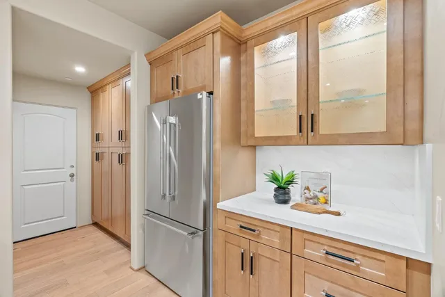 a white refrigerator freezer sitting inside of a kitchen