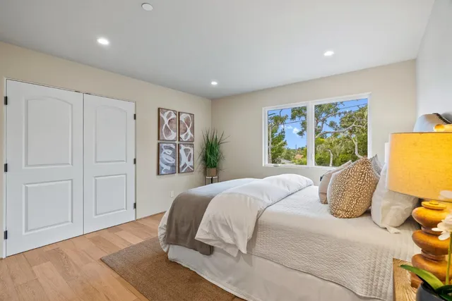 a bedroom with a large bed and a window