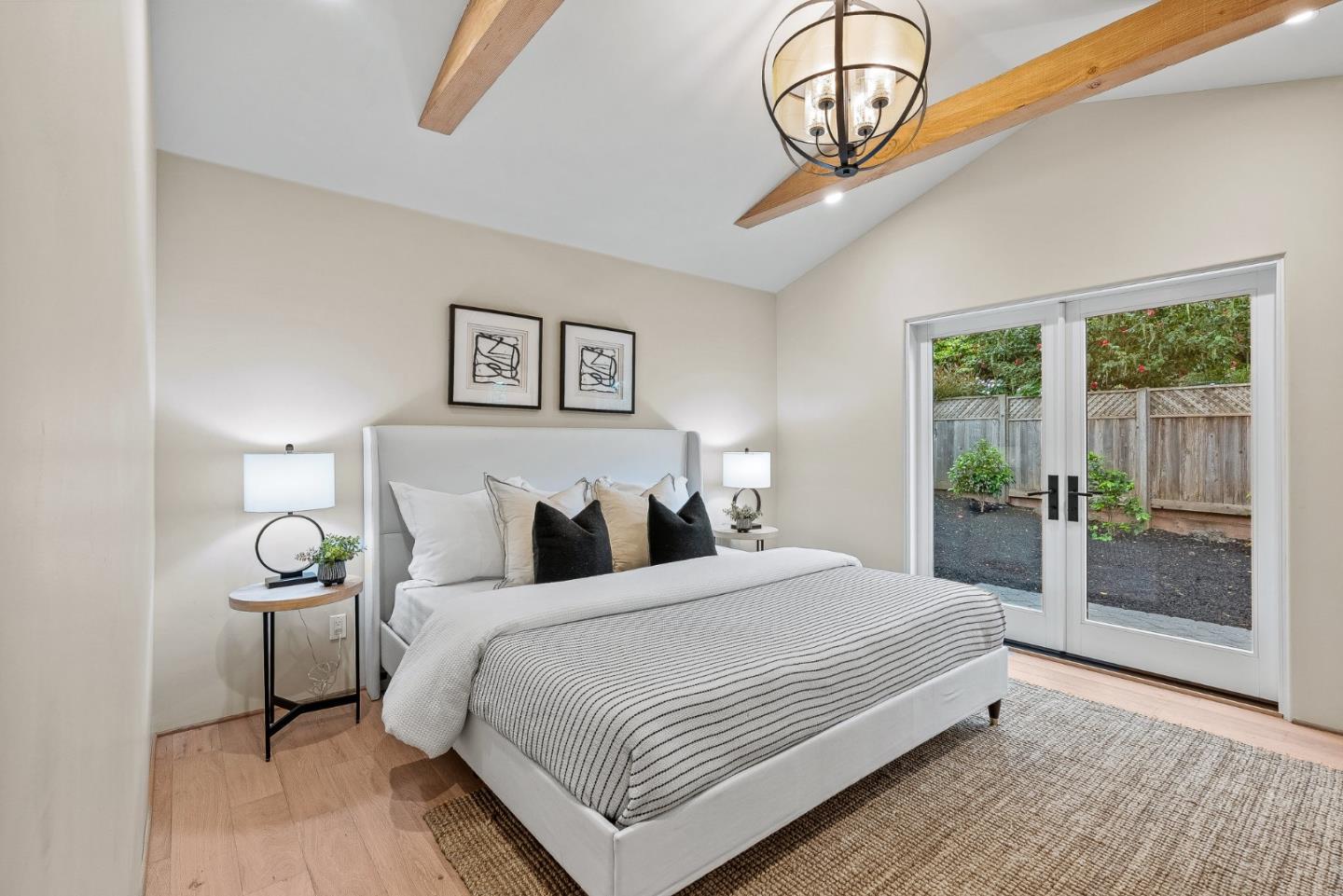 2869 Forest Lodge Road Pebble Beach, CA 93953 - Photo 20 of 34 a bedroom with a large bed and a window