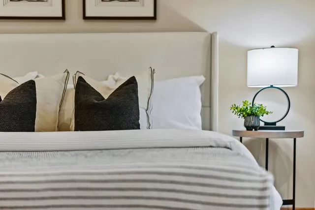 a bedroom with a bed and a potted plant
