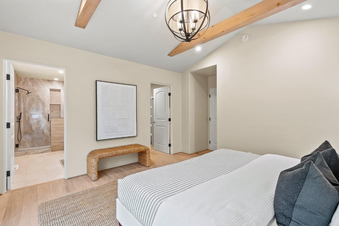 2869 Forest Lodge Road Pebble Beach, CA 93953 - Photo 22 of 34 a bedroom with a bed and a chandelier