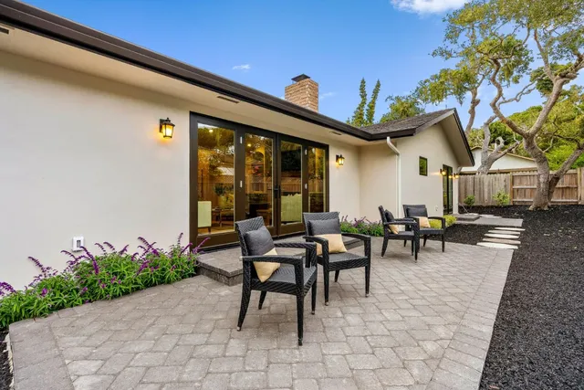 a view of a patio with table and chairs and potted plants